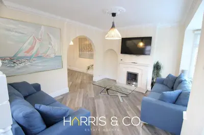 a living room with blue couches and a fireplace at Poolfoot Villas in Thornton