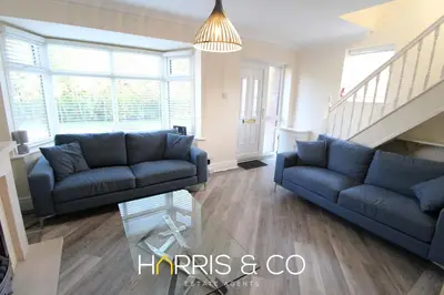 a living room with two blue couches and a staircase at Poolfoot Villas in Thornton