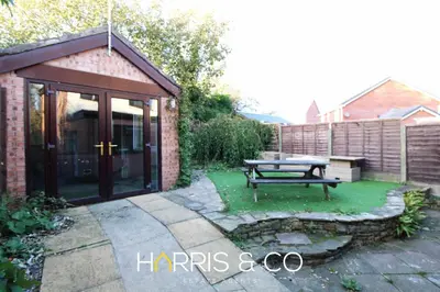 a patio with a picnic table in a garden at Poolfoot Villas in Thornton