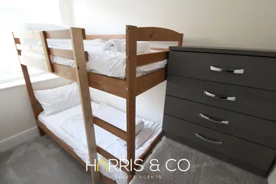 a bunk bed with a dresser in a room at Poolfoot Villas in Thornton