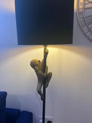 a statue of a person sitting on a floor lamp at Waterside Cottage in Preston