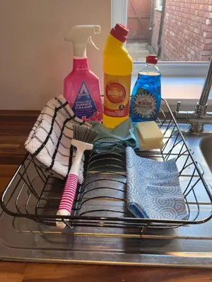 a rack with toiletries and cleaning products on a sink at Waterside Cottage in Preston