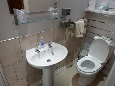 a bathroom with a white toilet and a sink at The Craimar in Blackpool