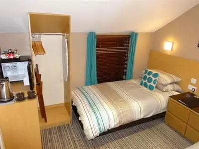 a small bedroom with a bed and a window at The Craimar in Blackpool