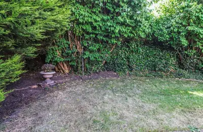 a garden with a planter in the middle of a yard at Zetland House Apartment - First floor with garden and parking in Southport