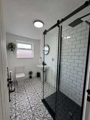 a bathroom with a shower with a toilet and a sink at Zetland House Apartment - First floor with garden and parking in Southport