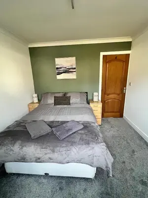 a bedroom with a large bed with two pillows on it at Holiday Bungalow in Arnside in Arnside