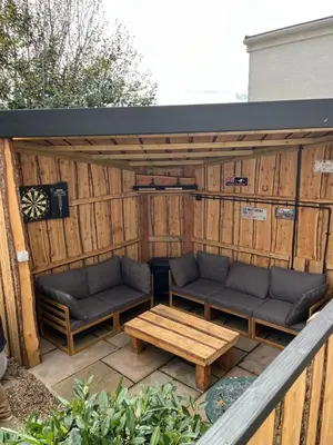 a pergola with two couches and a coffee table at Holiday Bungalow in Arnside in Arnside