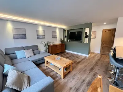 a living room with a couch and a table at Holiday Bungalow in Arnside in Arnside