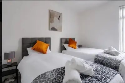 a bedroom with two beds with stuffed animals on them at Providence Luxury Apartment in Liverpool