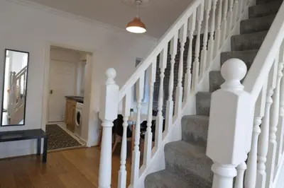 a staircase with white railings in a home at Providence Luxury Apartment in Liverpool