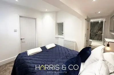 a bedroom with a bed with a blue comforter at Kittiwake in Fleetwood