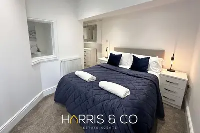 a bedroom with a large bed with two pillows at Kittiwake in Fleetwood