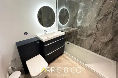 a bathroom with a sink and a tub and a toilet at Kittiwake in Fleetwood