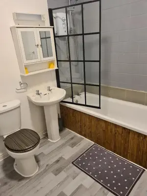 a bathroom with a toilet and a sink and a tub at The Eagle and Child in Garstang