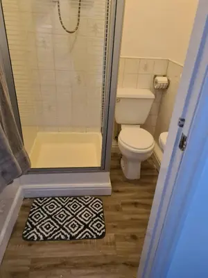 a small bathroom with a toilet and a shower at The Eagle and Child in Garstang
