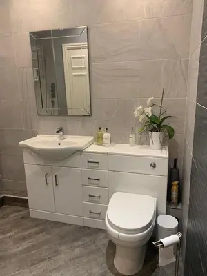 a bathroom with a toilet and a sink and a mirror at Shore Cottage A traditional cosy cottage in Wilpshire