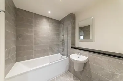 a bathroom with a tub and a toilet and a sink at Spacious 1 Bedroom Apartment in Central Liverpool in Liverpool