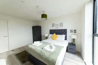 a bedroom with a large bed and a window at Spacious 1 Bedroom Apartment in Central Liverpool in Liverpool