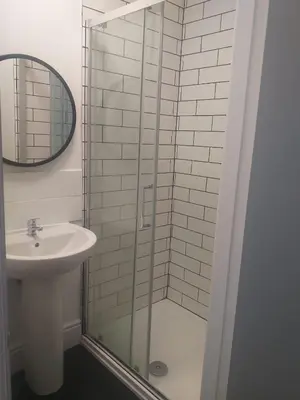 a bathroom with a sink and a glass shower at Liverpool 3-Bed House - Sleeps 6 in Liverpool