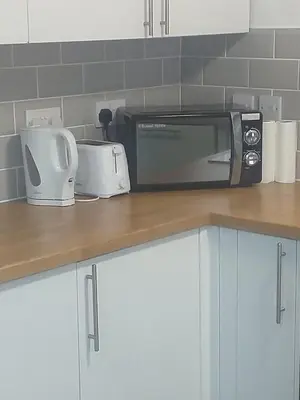 a microwave sitting on top of a kitchen counter at Liverpool 3-Bed House - Sleeps 6 in Liverpool