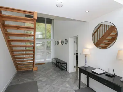 a staircase in a room with a desk and a mirror at Edgemere Cottage in Grange Over Sands