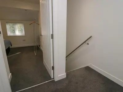 an empty room with a stairway in a house at Edgemere Hideaway in Grange Over Sands