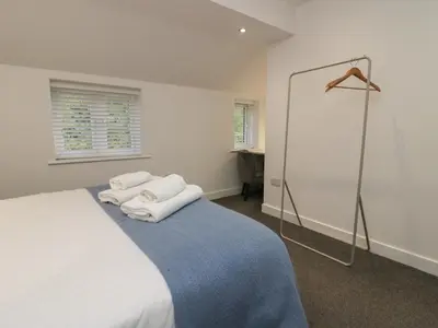 a bedroom with a bed with towels on it at Edgemere Retreat in Grange Over Sands