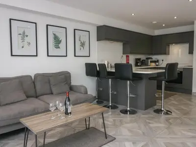 a living room with a couch and a table at Edgemere Retreat in Grange Over Sands
