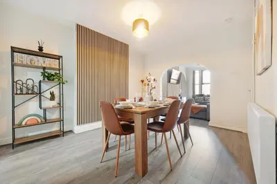 a dining room with a table and chairs at Miranda House - Air Host & Stay - Sleeps 7 in Liverpool