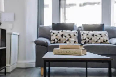 two boxes on a coffee table in a living room at Miranda House - Air Host & Stay - Sleeps 7 in Liverpool