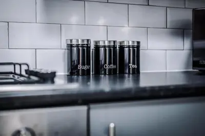 three coffee cups sitting on a counter in a kitchen at Miranda House - Air Host & Stay - Sleeps 7 in Liverpool