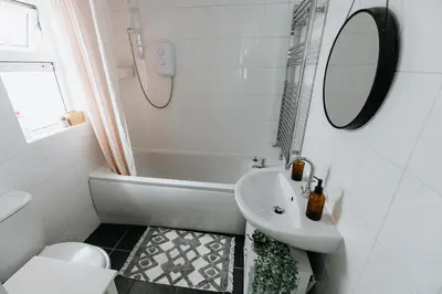 a bathroom with a sink and a tub and a toilet at SUN COTTAGE - Cosy Cottage in Ulverston with a log burner in Ulverston, Cumbria in Ulverston