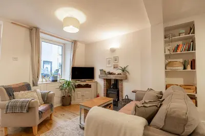 a living room with a couch and chairs and a tv at SUN COTTAGE - Cosy Cottage in Ulverston with a log burner in Ulverston, Cumbria in Ulverston
