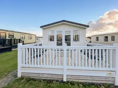 a white house with a white fence at Edith Rose in Middleton
