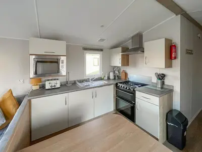 a kitchen with white cabinets and a stove top oven at Edith Rose in Middleton