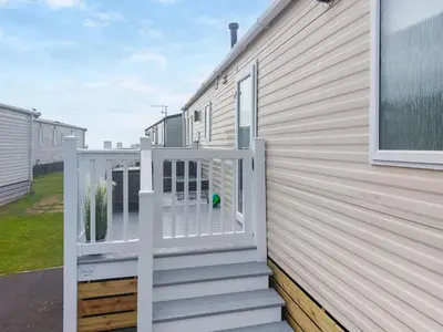 a balcony with a gate on a house at Marni's Seaview in Heysham