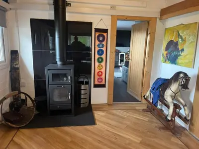 a room with a wood stove with a horse statue at Fearless Fox Lodge in Altham