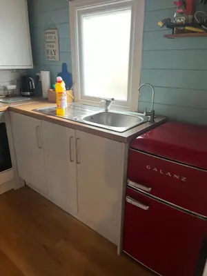 a kitchen with a sink and a red refrigerator at Fearless Fox Lodge in Altham