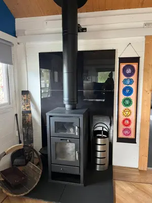 a fireplace in a room with a stove in it at Fearless Fox Lodge in Altham