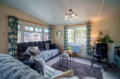 a living room with a couch and a chair at Peaceful 3-Bed Lodge ! Ideal for Families! in Warton