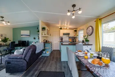 a kitchen and living room with a table with food at Peaceful 3-Bed Lodge ! Ideal for Families! in Warton