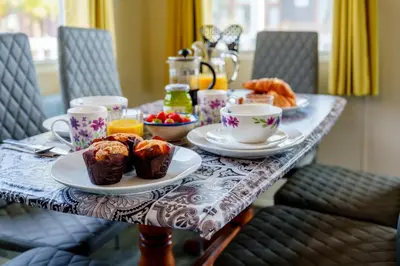 a table with cups of coffee and pastries on it at Peaceful 3-Bed Lodge ! Ideal for Families! in Warton