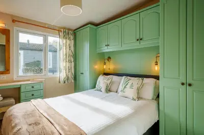 a green bedroom with a bed and a window at Peaceful 3-Bed Lodge ! Ideal for Families! in Warton
