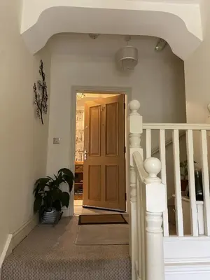 a staircase with a wooden door in a house at Priory Gardens – Birkdale - 2 bed in Southport