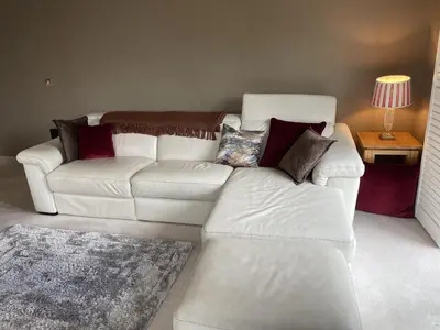 a living room with a white couch and a table at Priory Gardens – Birkdale - 2 bed in Southport