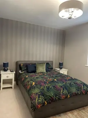 a bedroom with a bed and two night stands at Priory Gardens – Birkdale - 2 bed in Southport