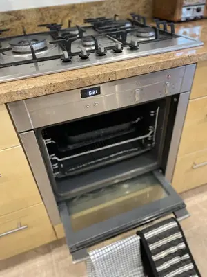 an oven with its door open in a kitchen at Priory Gardens – Birkdale - 2 bed in Southport