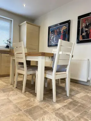a dining room table with two white chairs around it at Priory Gardens – Birkdale - 2 bed in Southport