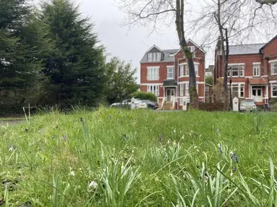 a field of tall grass in front of a house at Priory Gardens – Birkdale - 2 bed in Southport